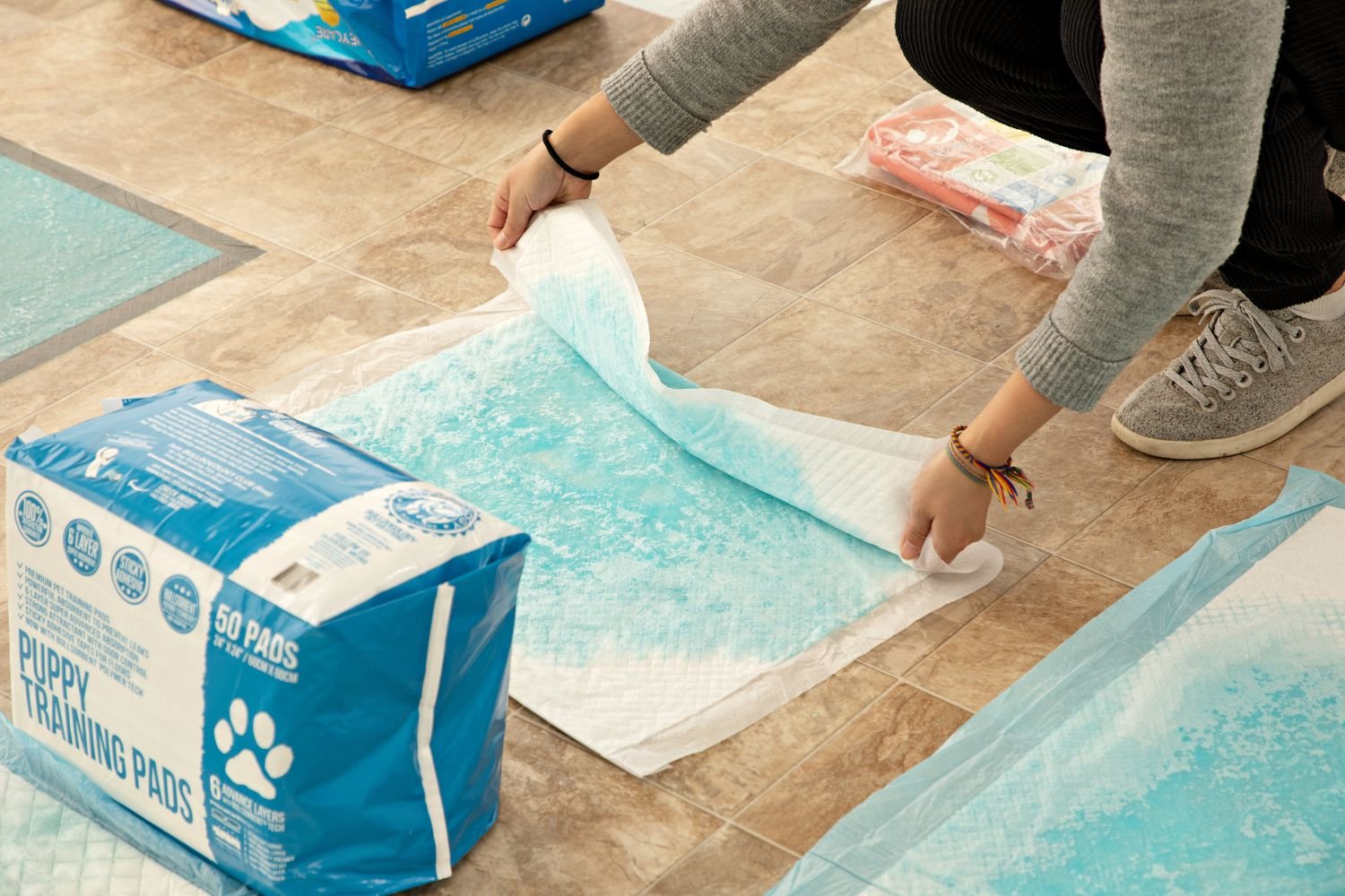 A person folding the Bulldogology Puppy Training Pads