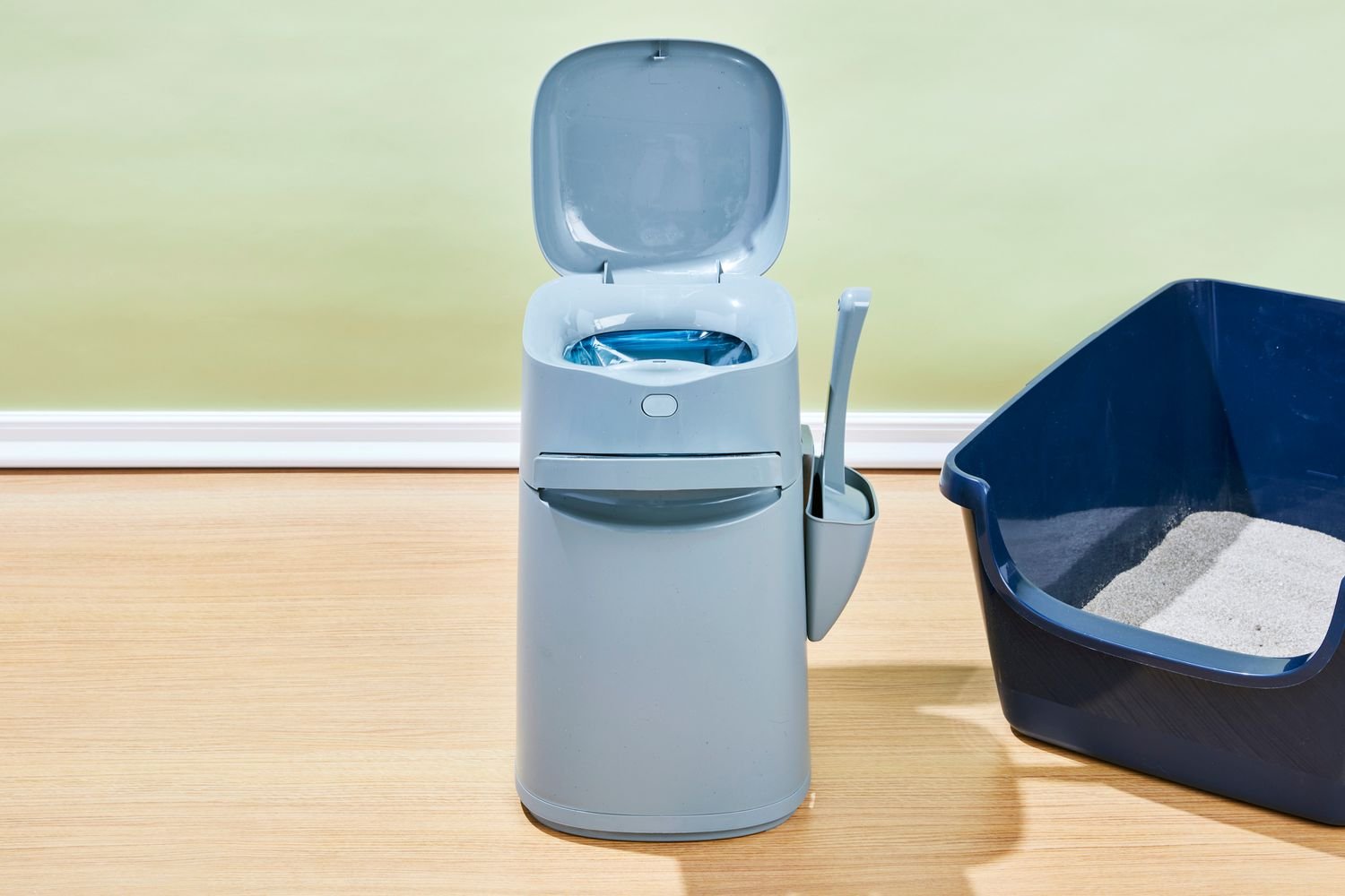The Litter Genie Easy Roll Cat Litter Disposal System and a litter box on the floor