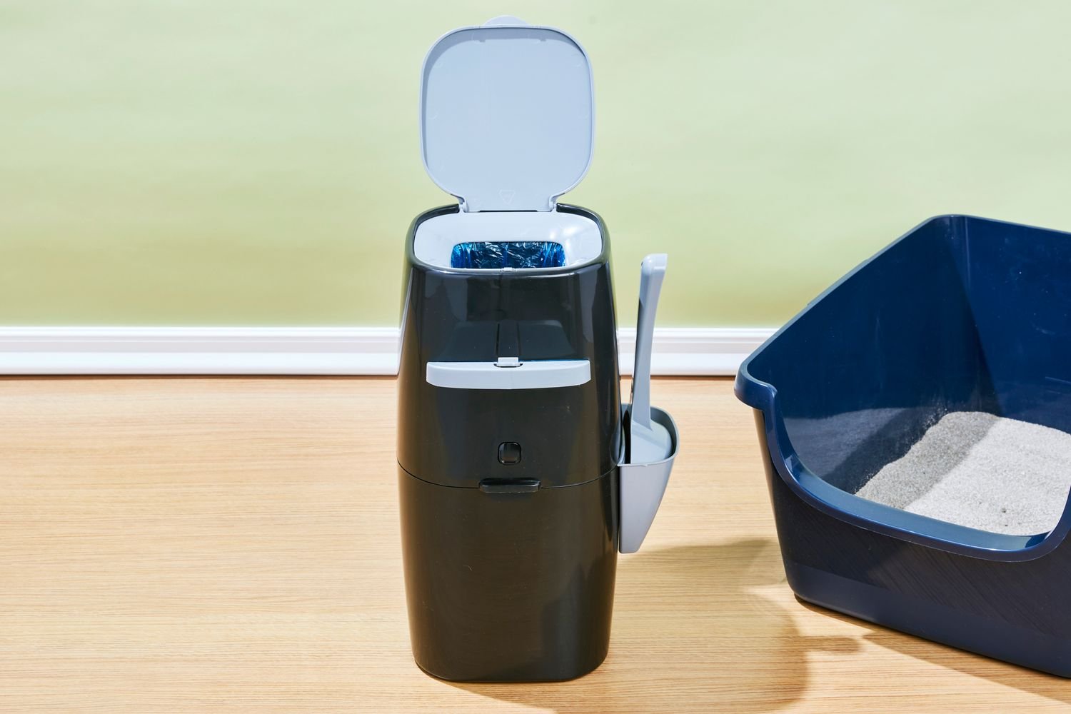 The Litter Genie Plus Cat Litter Disposal System and a litter box on the floor
