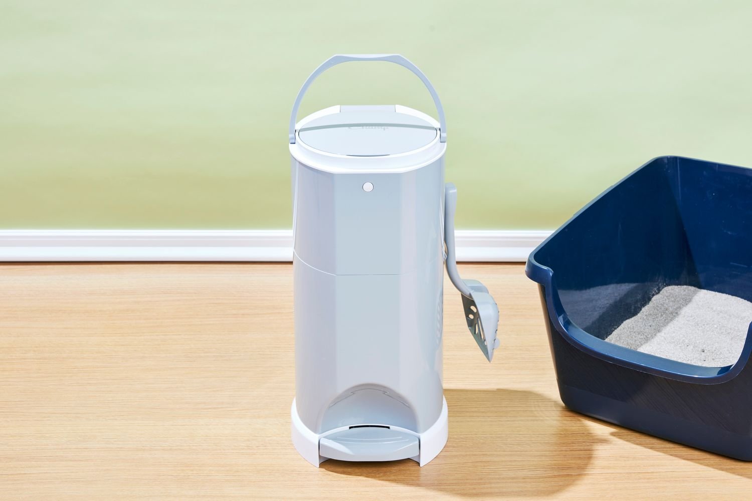 The Litter Champ Disposal System and a litter box on the floor