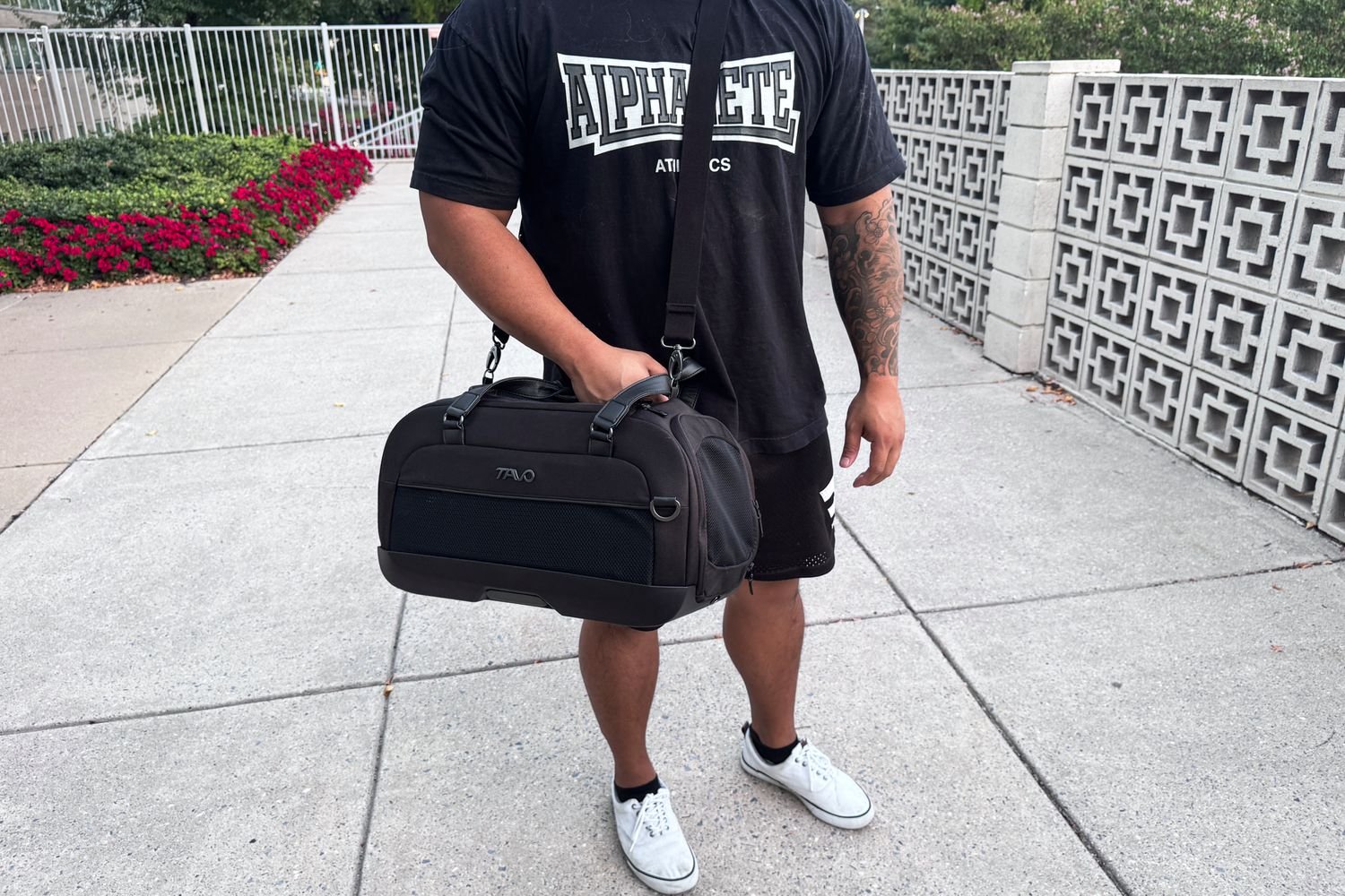 A person carries the Tavo Dupree Carry-On Pet Car Seat on their shoulder