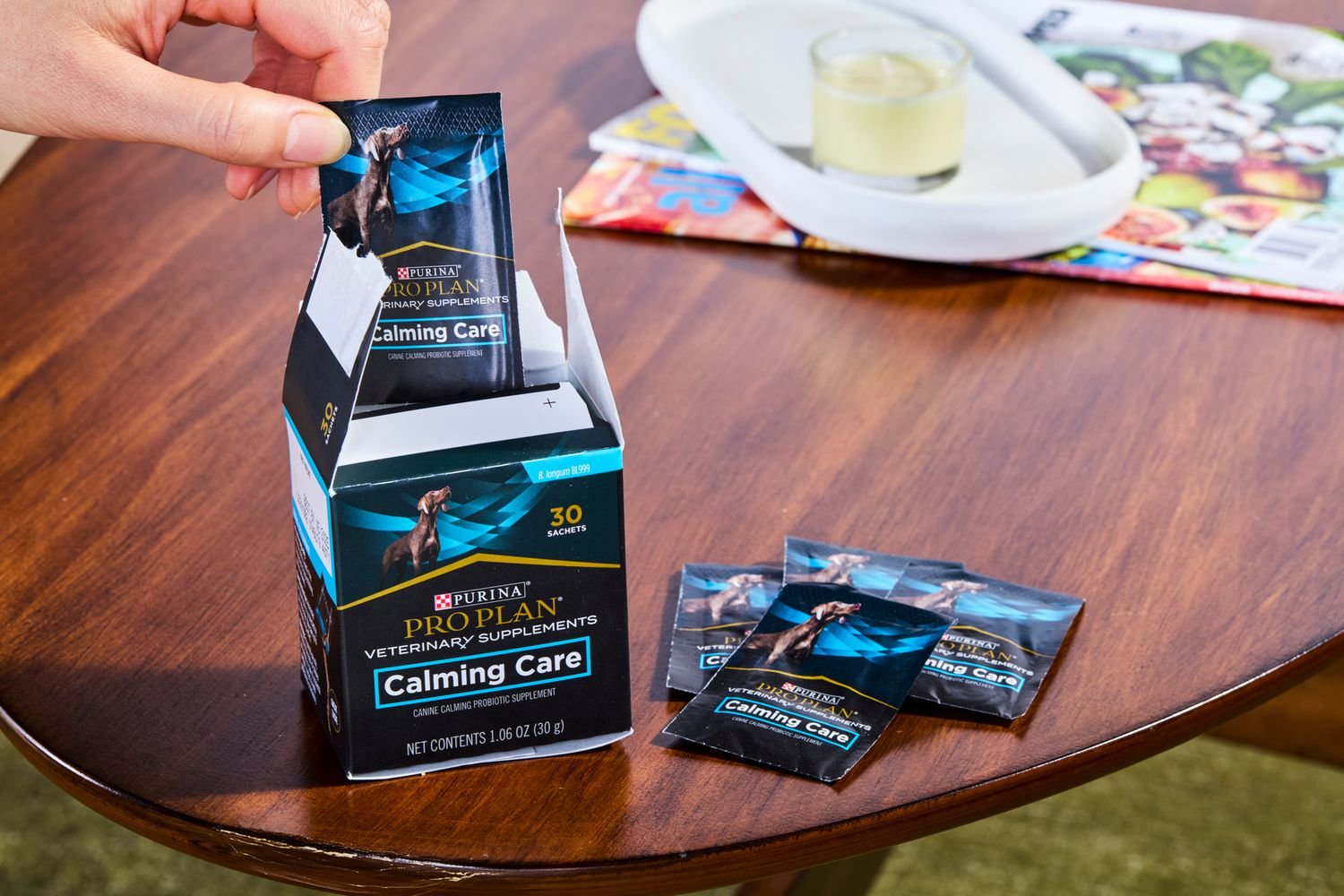 a person taking out packets of Purina Pro Plan Cat Calming Care Veterinary Supplements